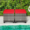 Two outdoor rattan ottomans with red removable cushions, perfect for patio or poolside relaxation and comfort.