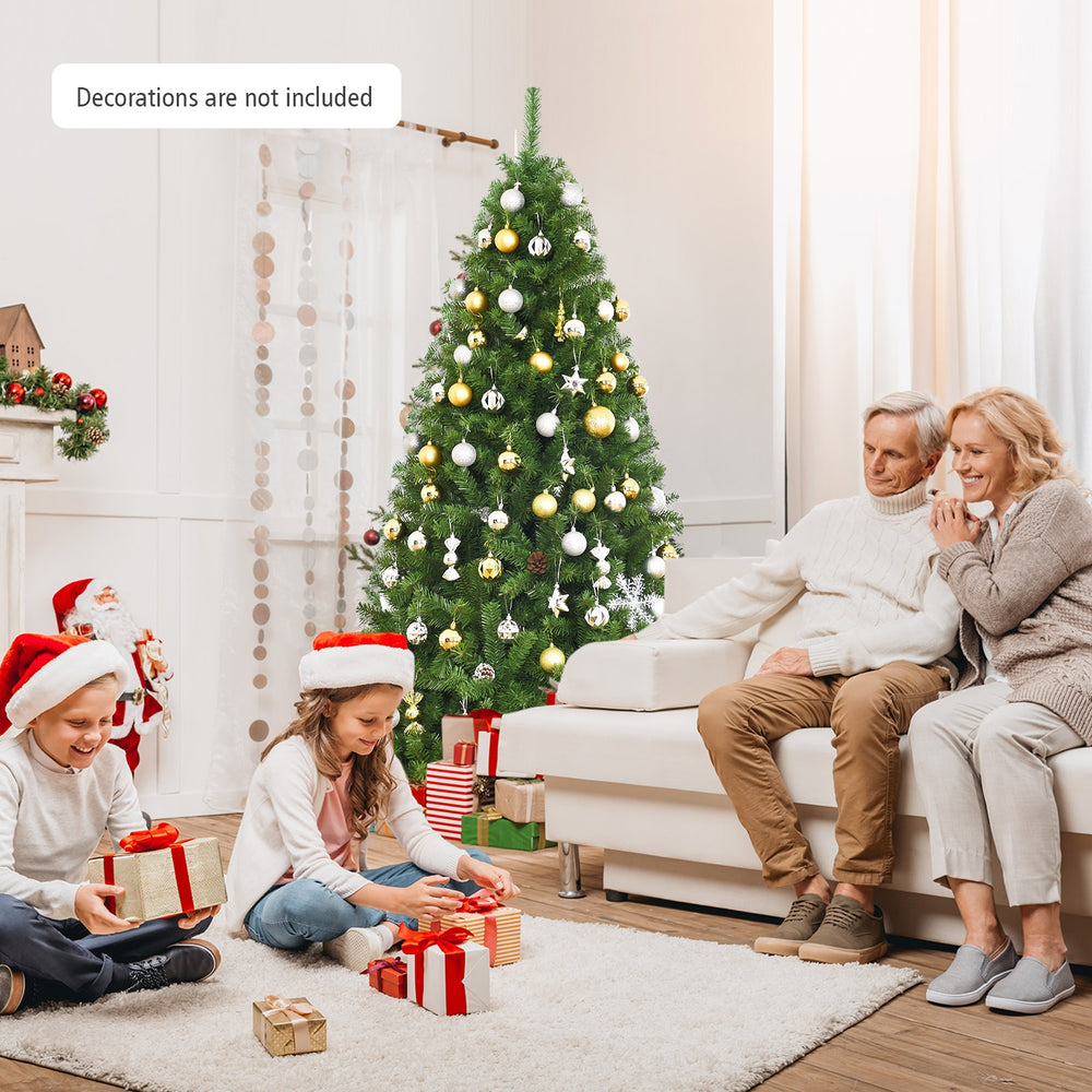 6 ft PVC artificial Christmas tree with 1346 tips, set up in a cozy indoor setting for festive holiday decoration.