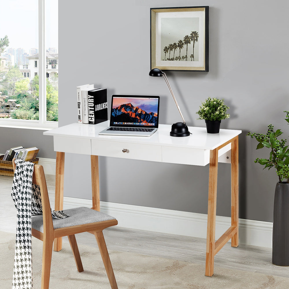 Side view of the white computer desk showcasing its spacious surface and sturdy rubberwood legs, perfect for any room.