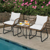 Two cushioned armchairs and a glass table in a patio setting, featuring weather-resistant PE rattan for outdoor.