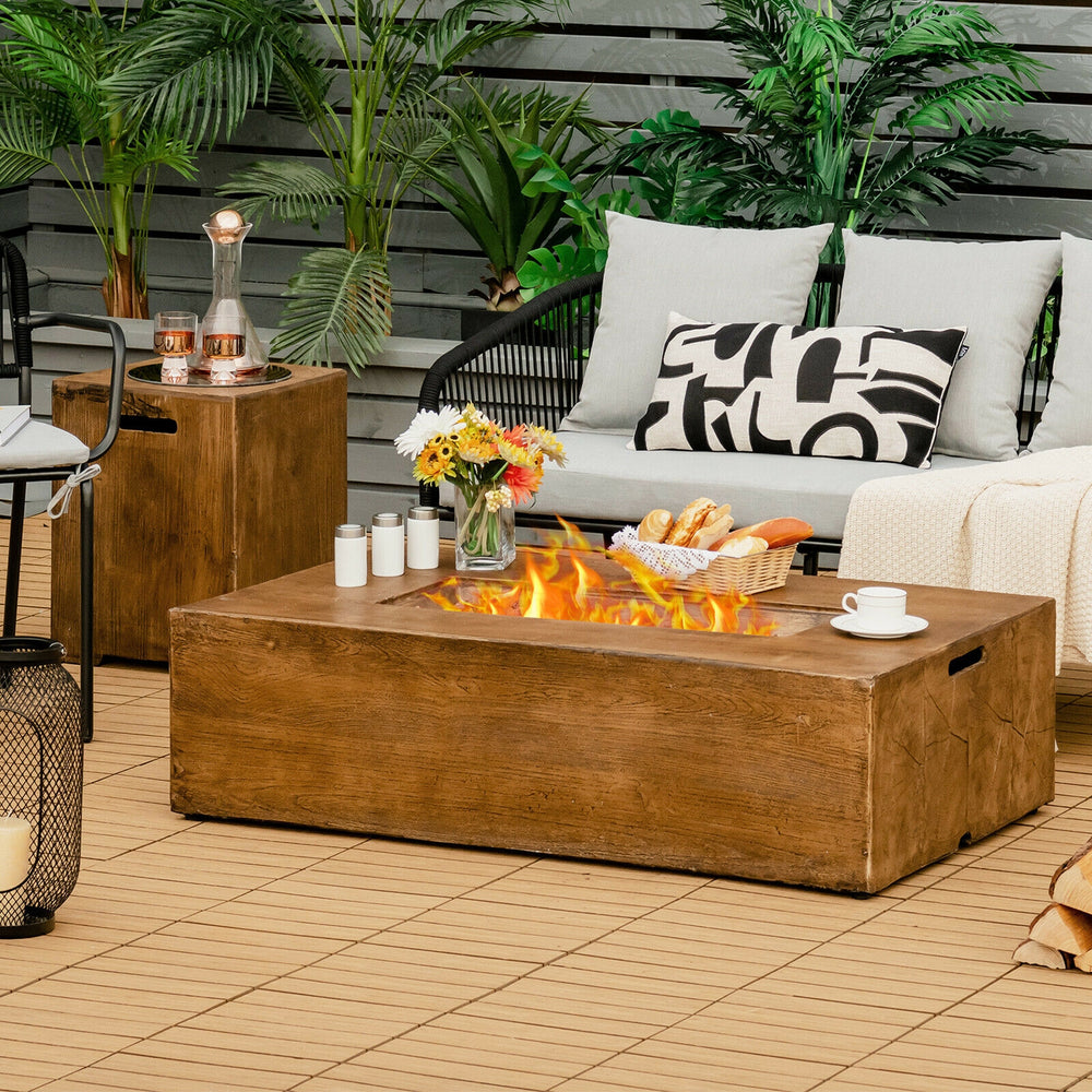 Rectangular 48" outdoor gas fire pit table with lava rocks, 50,000 BTU, and rustic wood grain finish for patio warmth.