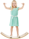 Child standing on a 12-inch natural birch wobble board in a garden, promoting balance and coordination skills.