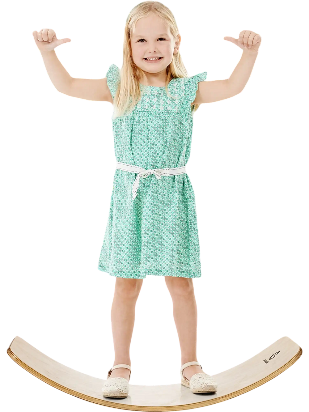 Child standing on a 12-inch natural birch wobble board in a garden, promoting balance and coordination skills.