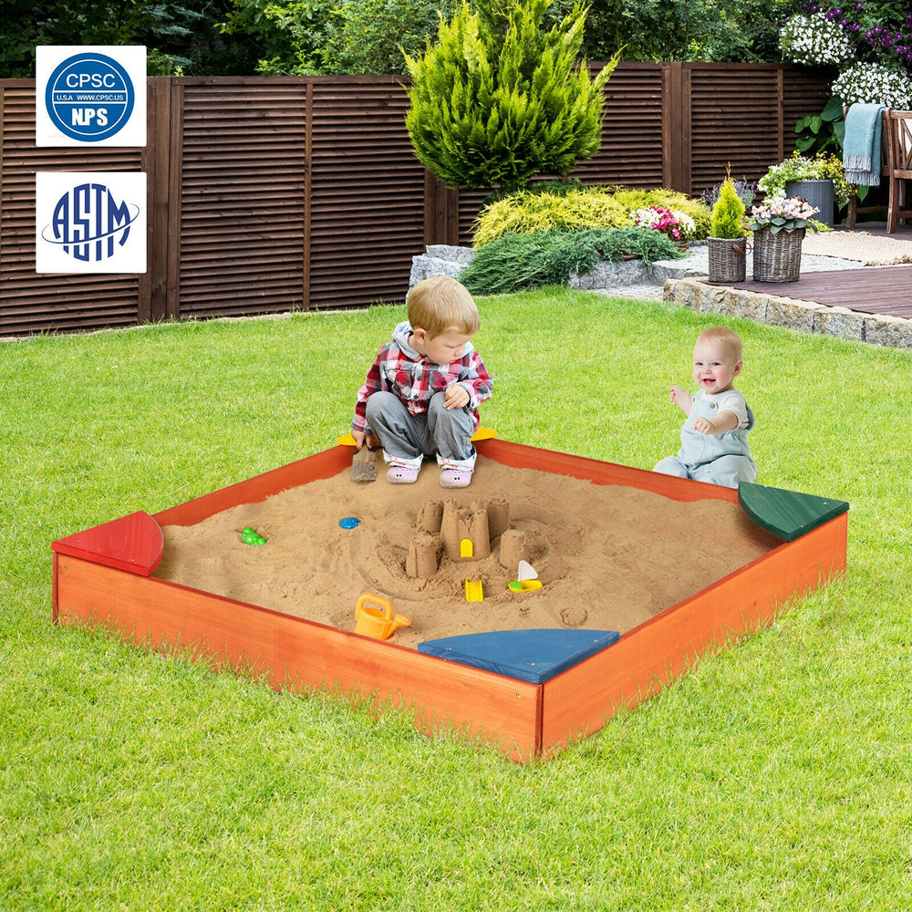 Kids playing in a colorful wooden sandbox with built-in corner seating, made of cedar and pine for outdoor fun.