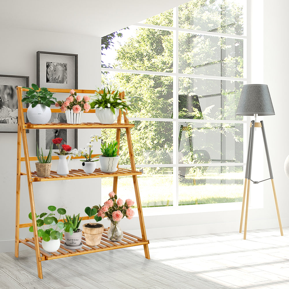 3-tier bamboo foldable plant stand with potted plants, showcasing natural finish for indoor and outdoor use.