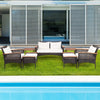 7-piece patio rattan cushioned conversation set featuring a loveseat, chairs, and tables, perfect for outdoor.
