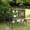 Three-tier metal plant stand in a garden, featuring durable steel for potted plants and decorative items. Ideal for.