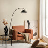 Modern orange accent armchair with side storage pocket, ergonomic design, and cozy backrest for living room comfort.