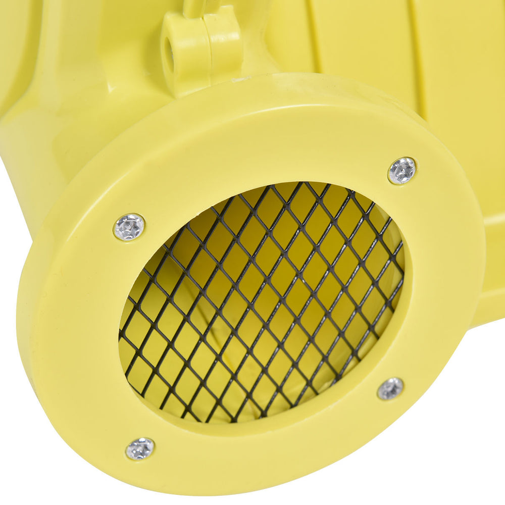 Close-up of the yellow air blower pump fan with a mesh grille, designed for inflatable bounce houses and outdoor use.