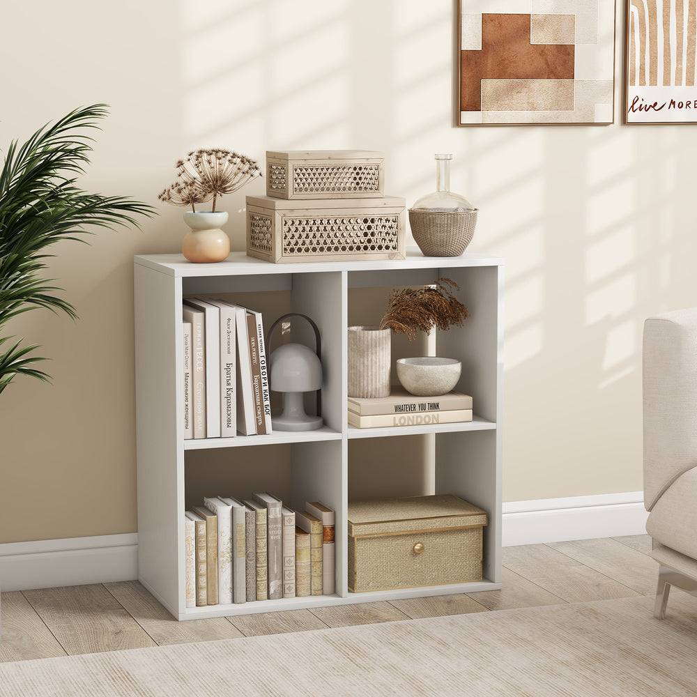 4-cube bookshelf in white with storage boxes and decor, ideal for living room or bedroom organization.