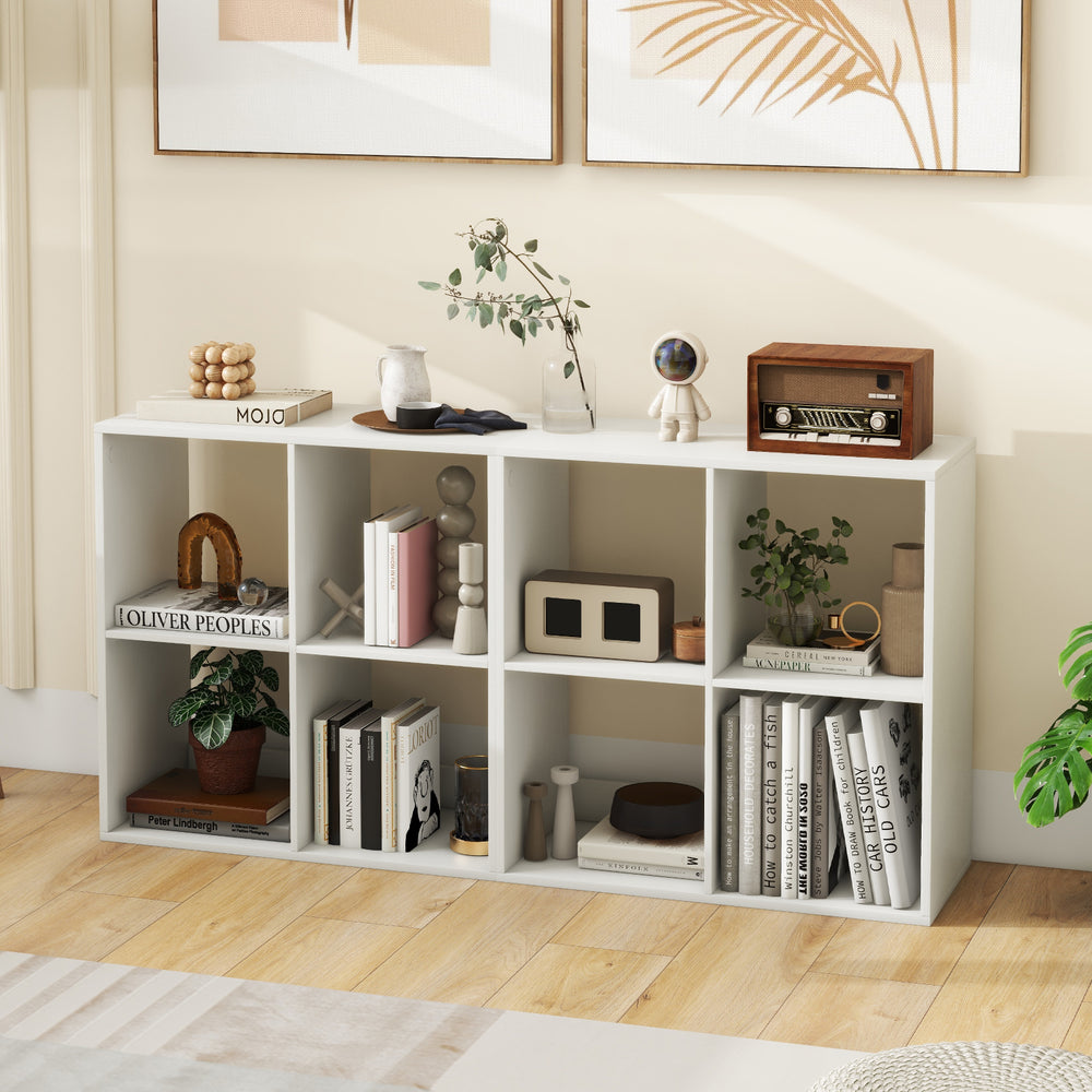 Four-cube bookshelf in white with back guardrail, ideal for storing books and decor in living room or bedroom.