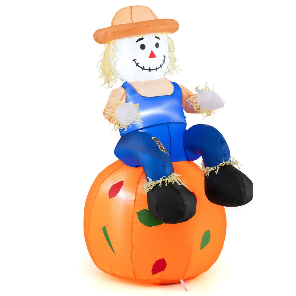 Cute 4 FT inflatable scarecrow sitting on a pumpkin, featuring LED lights, perfect for Halloween and Thanksgiving decorations.