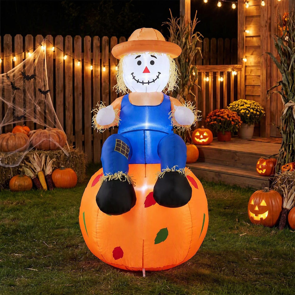 Cute 4 FT Halloween inflatable scarecrow sitting on a pumpkin, featuring bright LED lights for festive outdoor decoration.