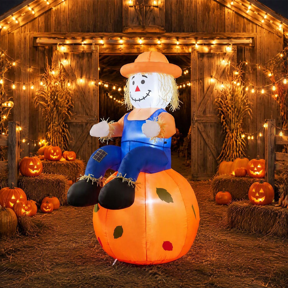 Cute 4 FT Halloween inflatable scarecrow sitting on a pumpkin, featuring LED lights for festive indoor or outdoor display.