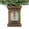 Antique urn base of a 4 feet pre-lit potted Christmas tree with flowering pine needles and warm LED lights.
