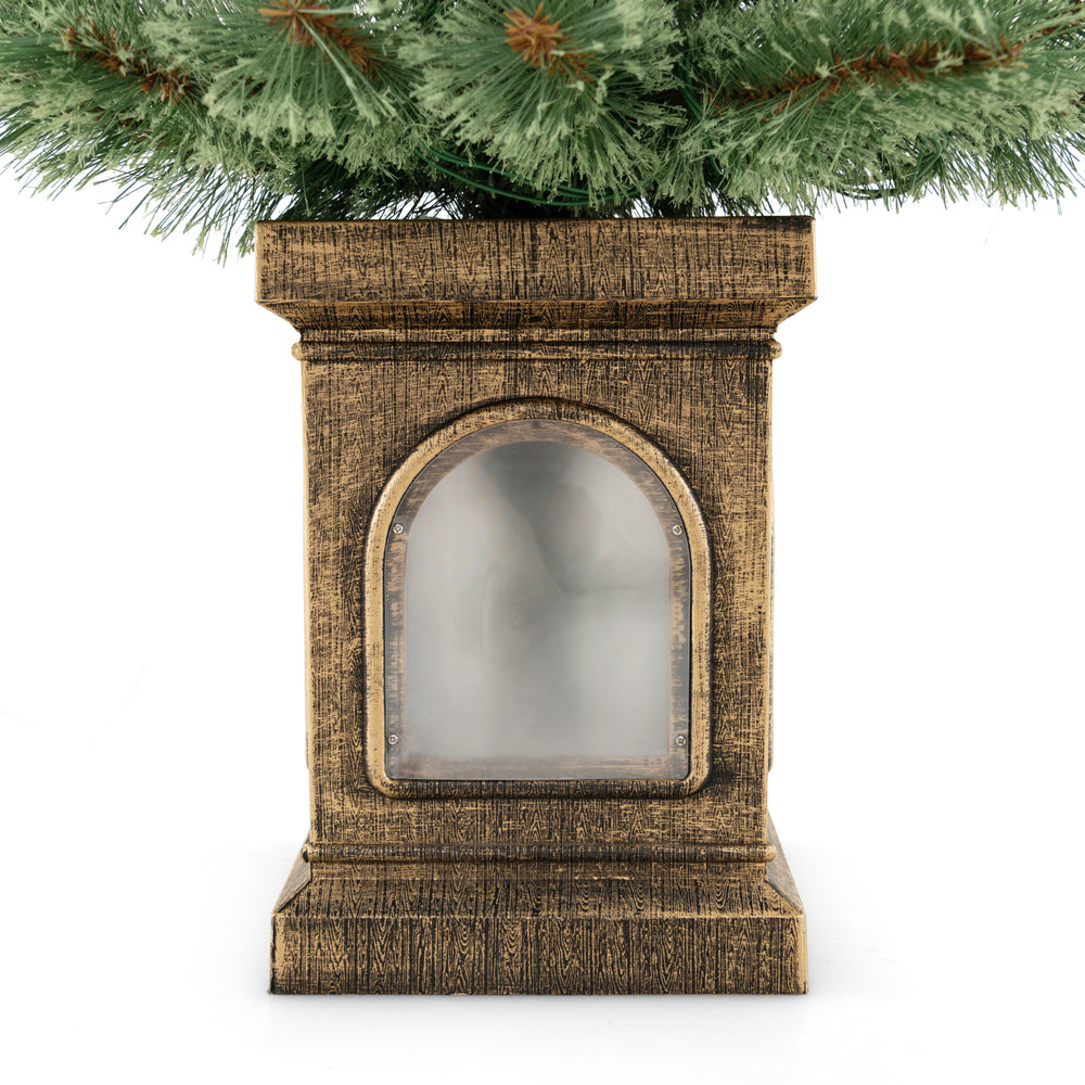 Antique urn base of a 4 feet pre-lit potted Christmas tree with flowering pine needles and warm LED lights.