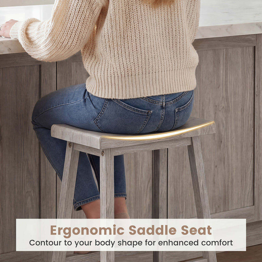 Ergonomic saddle seat of a counter height stool in a gray dining set, promoting comfort and relaxed posture.