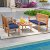 Acacia wood 4-piece patio furniture set with navy cushions, perfect for poolside relaxation and outdoor gatherings.