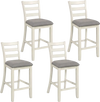 Set of four beige counter height chairs with fabric seats and rubber wood legs, perfect for dining and gatherings.