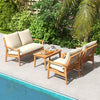 Outdoor acacia wood conversation set with soft cushions, featuring a loveseat and two armchairs by the poolside.