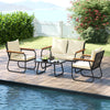 Patio furniture set featuring a loveseat and two chairs with cream cushions and a tempered glass coffee table for.