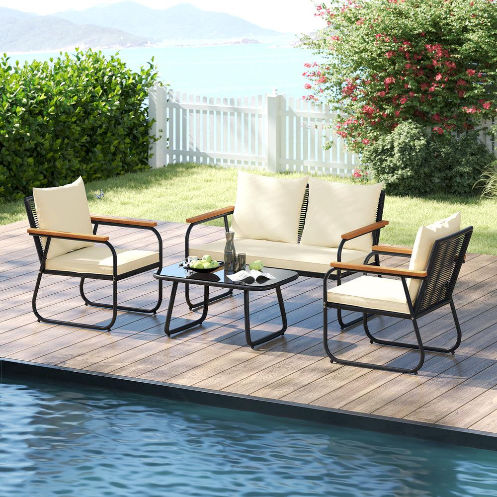 Patio furniture set featuring a loveseat and two chairs with cream cushions and a tempered glass coffee table for.