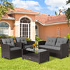 4-piece patio rattan furniture set featuring gray cushions, including a coffee table, loveseat, and two single sofas.
