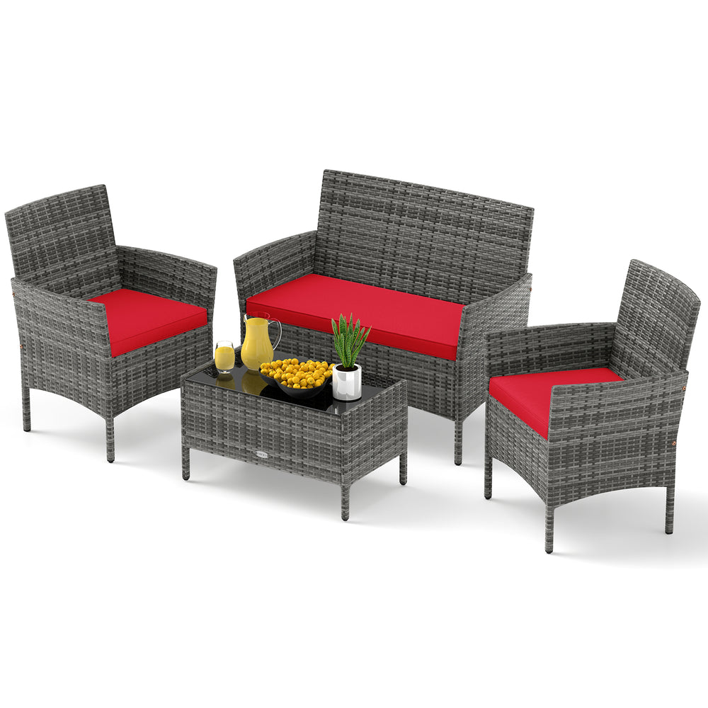 4-piece patio rattan conversation set with red cushions and tempered glass coffee table, perfect for outdoor relaxation.