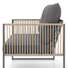 Side view of a grey outdoor PE rattan chair with thick cushions, featuring a sturdy metal frame for patio relaxation.