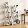4-tier white wooden bookshelf with decorative items, perfect for small spaces and enhancing room aesthetics.