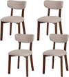 Set of 4 upholstered dining chairs with solid rubber wood frame and curved backrest for ergonomic comfort.