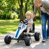 Child riding a white 4-wheel pedal go-kart with adjustable seat and steering wheel for outdoor fun.