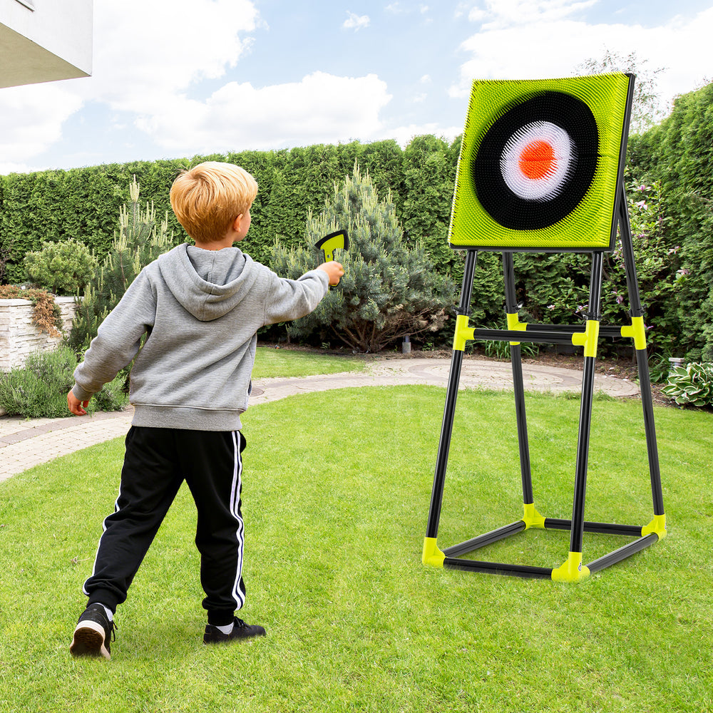 Child playing with the 4 in 1 throwing target set featuring a bristle target and throwing accessories for outdoor fun.