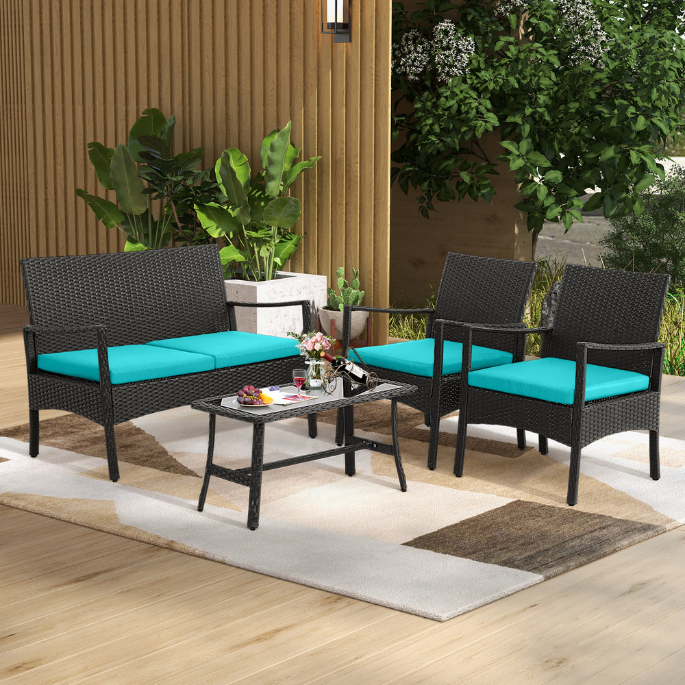 Turquoise cushion detail on a single rattan chair from the 4-piece conversation set, perfect for outdoor lounging.