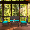 4-piece rattan conversation set with turquoise cushions, featuring a tempered glass coffee table for indoor relaxation.