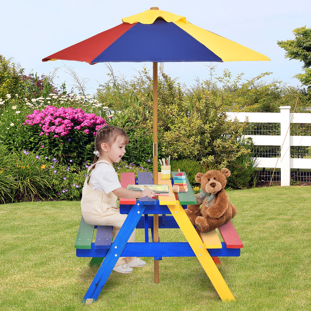 Child sitting at a vibrant kids picnic table with umbrella, made of eco-friendly fir wood, perfect for snacks and.