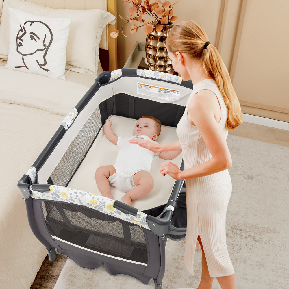 4 in 1 Portable Pack and Play Baby Nursery Center with Bassinet-Yellow - Gallery View 1 of 10