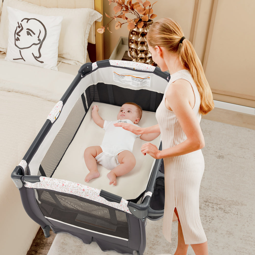4 in 1 Portable Pack and Play Baby Nursery Center with Bassinet-Heart Pink - Gallery View 1 of 10