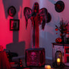 Life-sized 5.5ft Halloween animatronic decoration with light-up eyes, shaking wings, and a spooky praying posture.