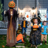 Animated 5.6 feet pumpkin scarecrow with posable arms, bright green lights, perfect for Halloween yard decor.