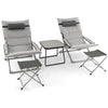 Two gray folding lounge chairs with footrests and a coffee table, perfect for patio relaxation and easy storage.