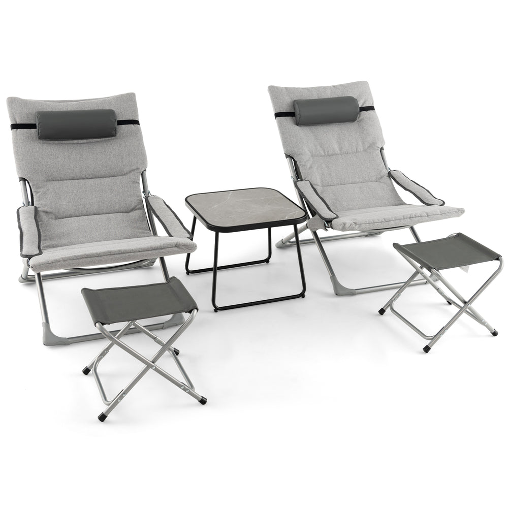 Two gray folding lounge chairs with footrests and a coffee table, perfect for patio relaxation and easy storage.