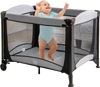 Portable baby playard in black with mesh sides, removable cradle, and storage basket, ideal for versatile baby care.