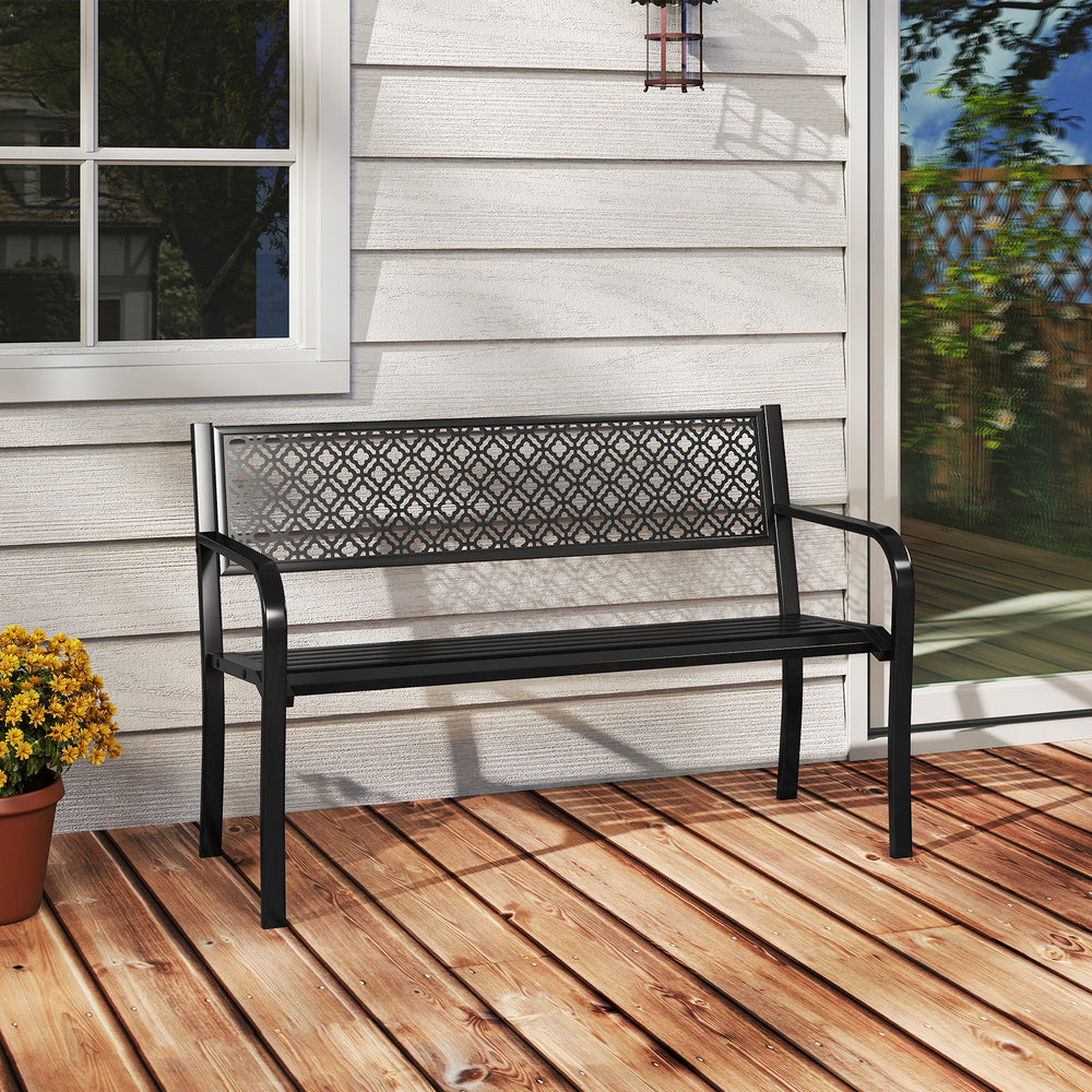 Black outdoor garden bench with geometric lattice backrest, slatted seat, and sturdy metal construction for patio use.