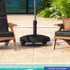Patio wicker style resin umbrella base stand with wheels, 50 lbs, for easy mobility and strong support at poolside.