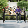 Outdoor cast iron metal patio bench with floral design, providing a cozy spot for 2-3 people in a garden setting.