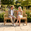 Teak outdoor porch bench with armrests, 3-seat capacity, perfect for garden relaxation and ergonomic comfort.