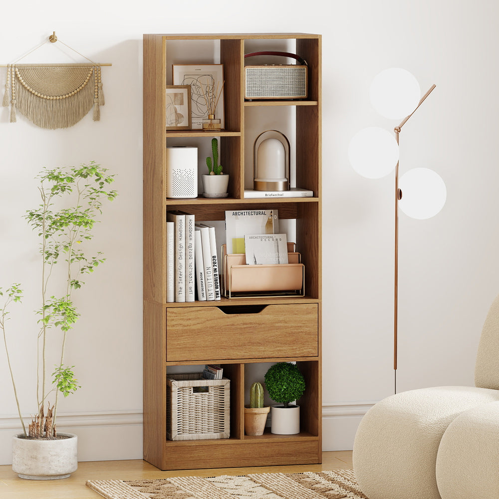Tall freestanding bookcase with 7 open cubes and a drawer in natural finish, ideal for stylish storage and organization.