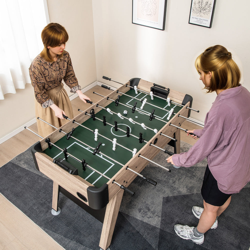 Two players enjoying a 54-inch foosball table made of premium MDF, featuring 26 players and adjustable leg levelers.
