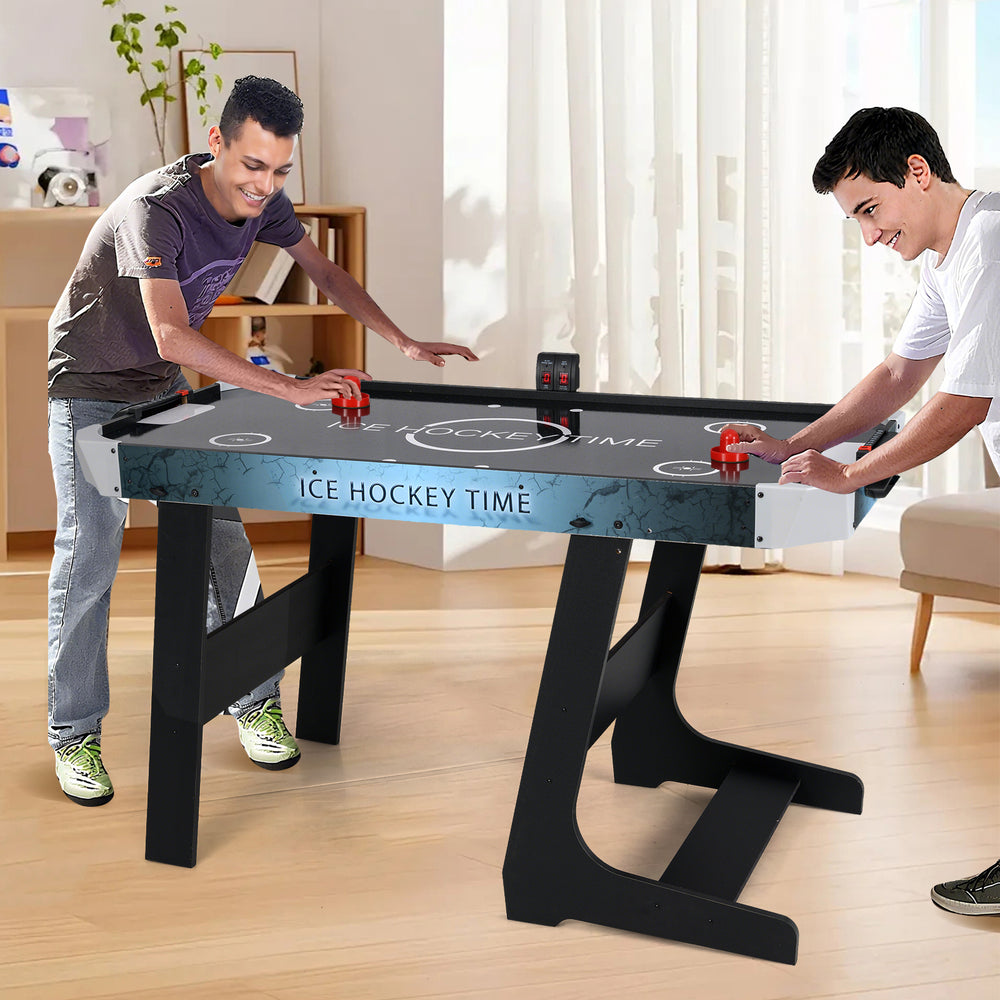 56-inch air hockey table with LED scoreboard, featuring two players in action, ideal for small spaces and family fun.
